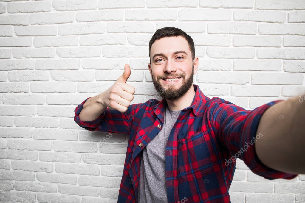 Happy man  making selfie  and showing thumb up  Stock Photo 
