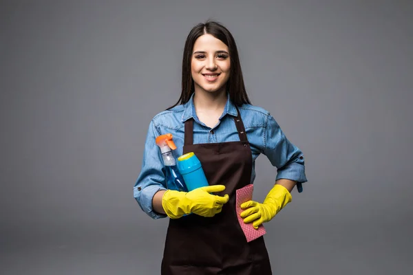 Smiling woman holding bottle of chemistry for cleaning house. Isolated portrait. — Stock Photo, Image