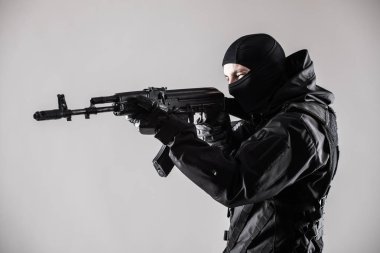 Gri arka plan üzerinde silahlı terörist amacı