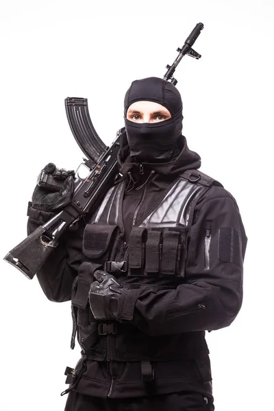Portrait of dangerous bandit in black wearing balaclava and holding gun in hand — Stock Photo, Image