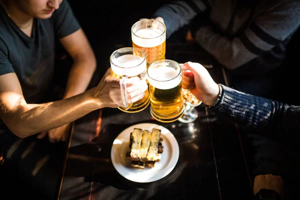 ¡Salud! Vista superior de cerca de personas sosteniendo tazas con cerveza — Foto de Stock