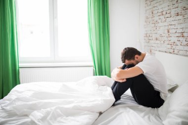 Onun yatağında evde oturan bir hasta adam