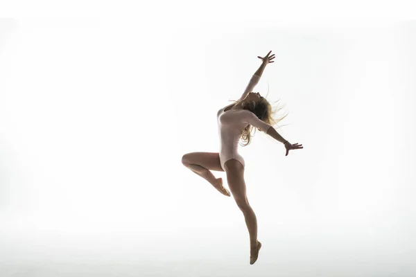 Joven gimnasta delgada en estudio sobre fondo blanco — Foto de Stock