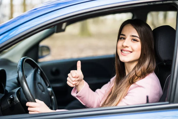 Hermosa mujer de negocios dando pulgar hacia arriba dentro de su coche — Foto de Stock