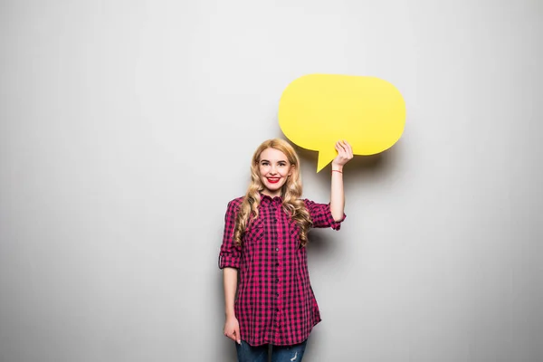 Hermosa joven rubia sosteniendo burbuja de habla en blanco amarillo sobre fondo gris — Foto de Stock