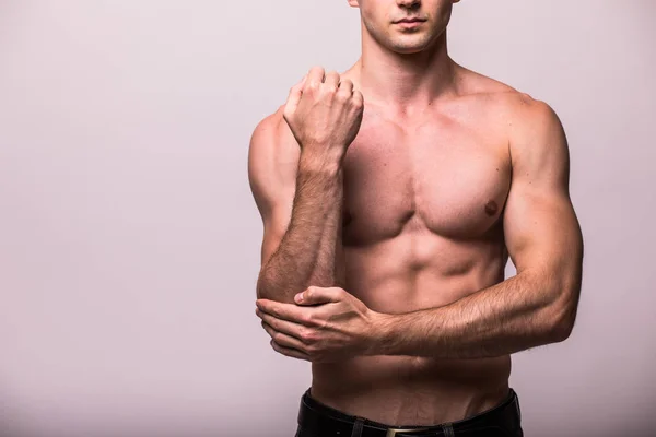 Young man having pain in his elbow on grey background — Stock Photo, Image