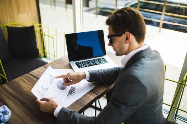 Girişimci ile bir dizüstü bilgisayar ve bir belge bir ofiste holding