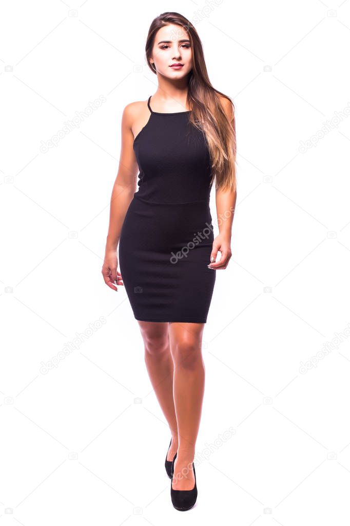 Young brunette lady in black dress posing on grey