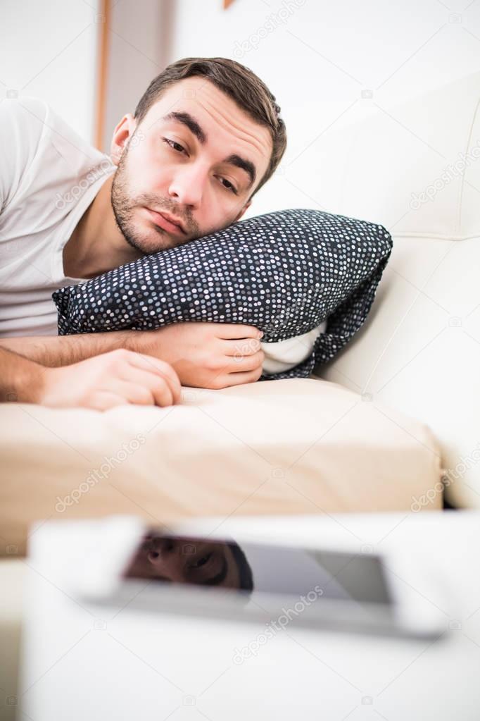 Man in bed woken by alarm on mobile phone at home