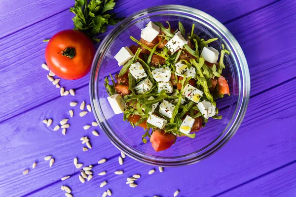 Ensalada griega fresca en un tazón en la mesa de lana, vista superior —  Fotos de Stock