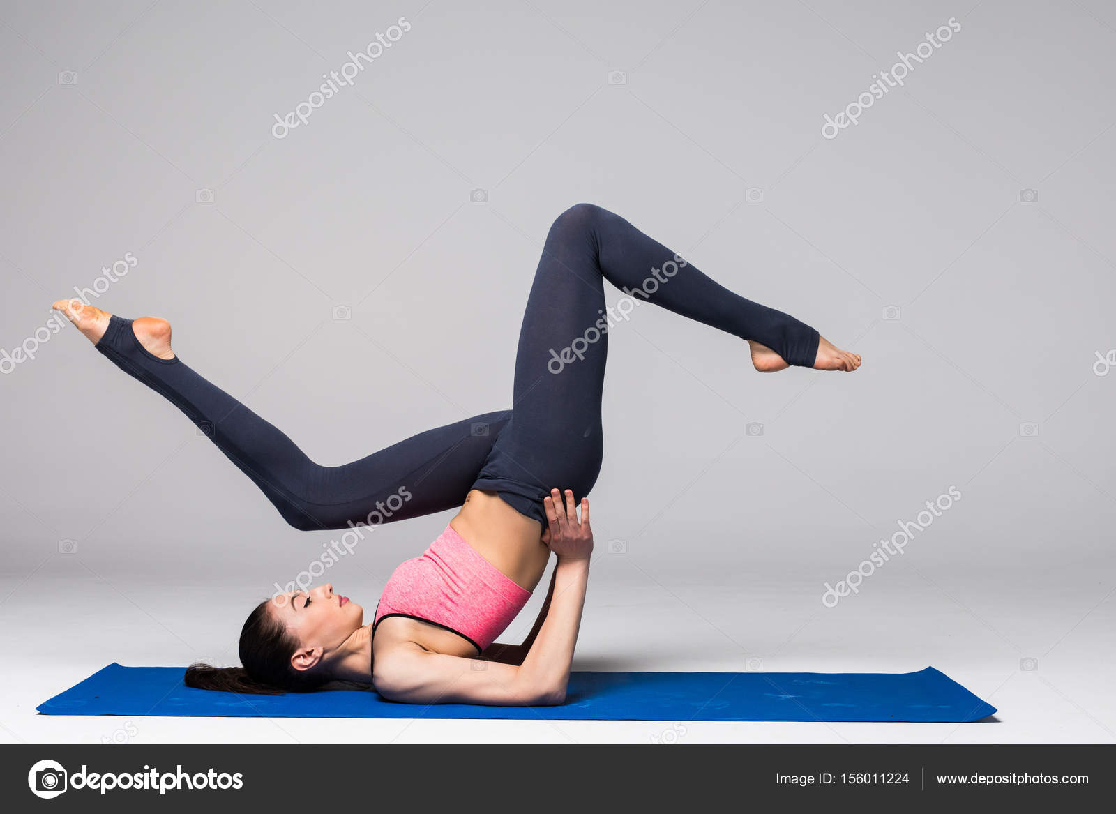 Young attractive woman practicing yoga, standing in different yoga  exercise, wearing sportswear isolated on grey background. Series of Yoga  position concept Stock Photo by ©dan.grytsku.gmail.com 156011224