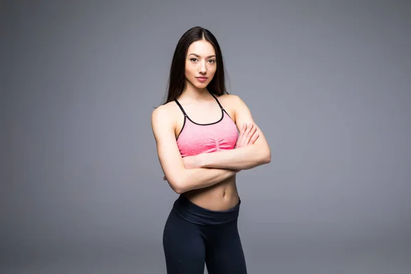 Mulher fitness em roupas esportivas posando em fundo cinza, tiro estúdio — Fotografia de Stock