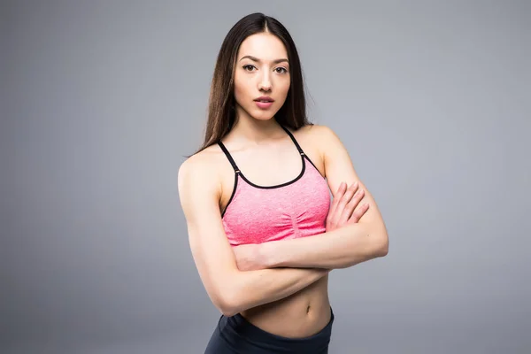 Mulher fitness em roupas esportivas posando em fundo cinza, tiro estúdio — Fotografia de Stock