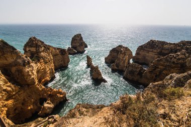 Turkuaz okyanus dalgası erozyon ile Atlantik kıyı şeridi güzel uçurumlarda mağaralar arka plan 