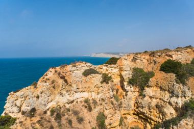 Yaz tatili kayalıklarla denizler ile kumsalda mağaralar deniz manzarası görünümünde kayaların üzerinde harcama. Yaz saati