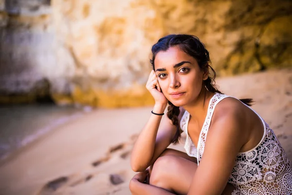 Potrait latin kız altın kum Beach yakınındaki kayaların üzerinde oturan ve ocean adlı arıyorum. Yaz meslek