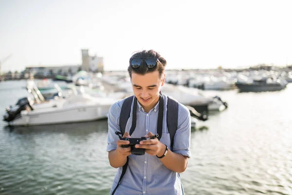 Joven asiático hombre mira taked foto en viajar cerca marina en viejo — Foto de Stock