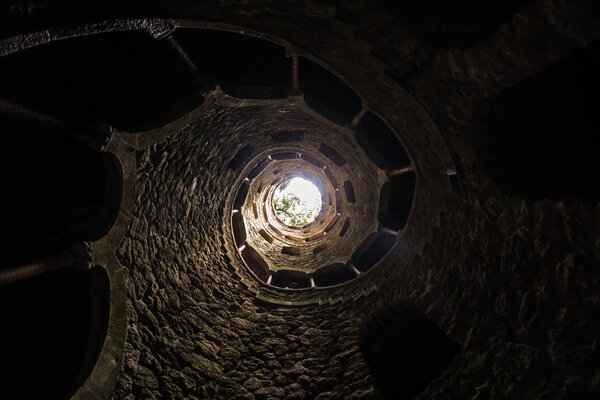 The Initiation well of Quinta da Regaleira in Sintra. The depth of the well is 27 meters. It connects with other tunnels through underground passages. Sintra. Portugal