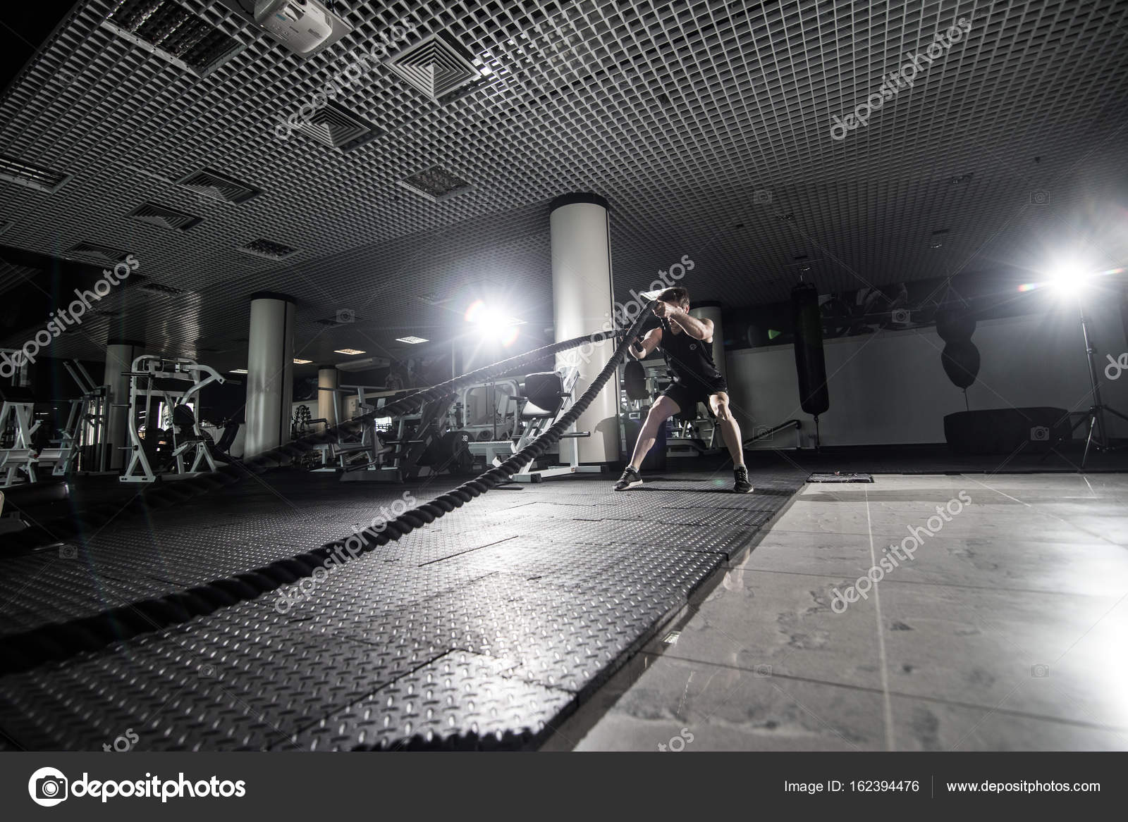 Fitness Man Working Out With Battle Ropes At Gym Battle