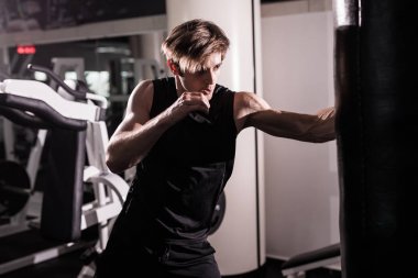 Eylem - kırmızı boks eldiven dövmeli bir adam - boks torbasına yumruk ile boksör