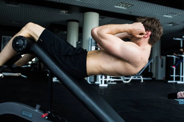 Homem muscular exercitando-se fazendo sentar-se exercício . — Fotografia de Stock