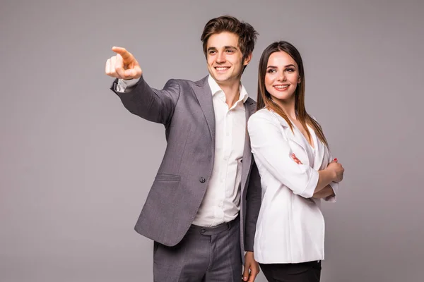The business man and woman on a gray background. Man pointed away on gray — Stock Photo, Image