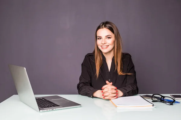 Affärskvinna som arbetar på sin laptop på kontoret medan affärsmän consulting i bakgrunden. — Stockfoto