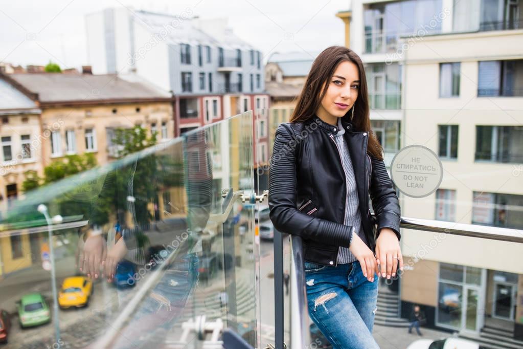 Young woman on terrace with stunning view of the city