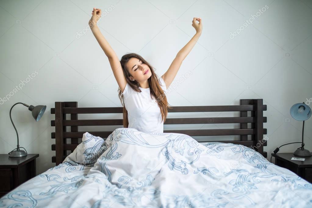 Happy morning of beauty woman streching in bed at home