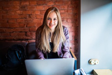 Bir kafede onu laptop kullanan genç ve güzel kadın