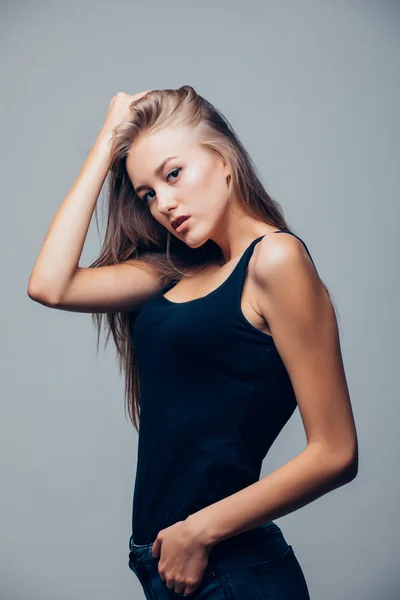 Hermosa joven con camisa negra sobre fondo gris — Foto de Stock