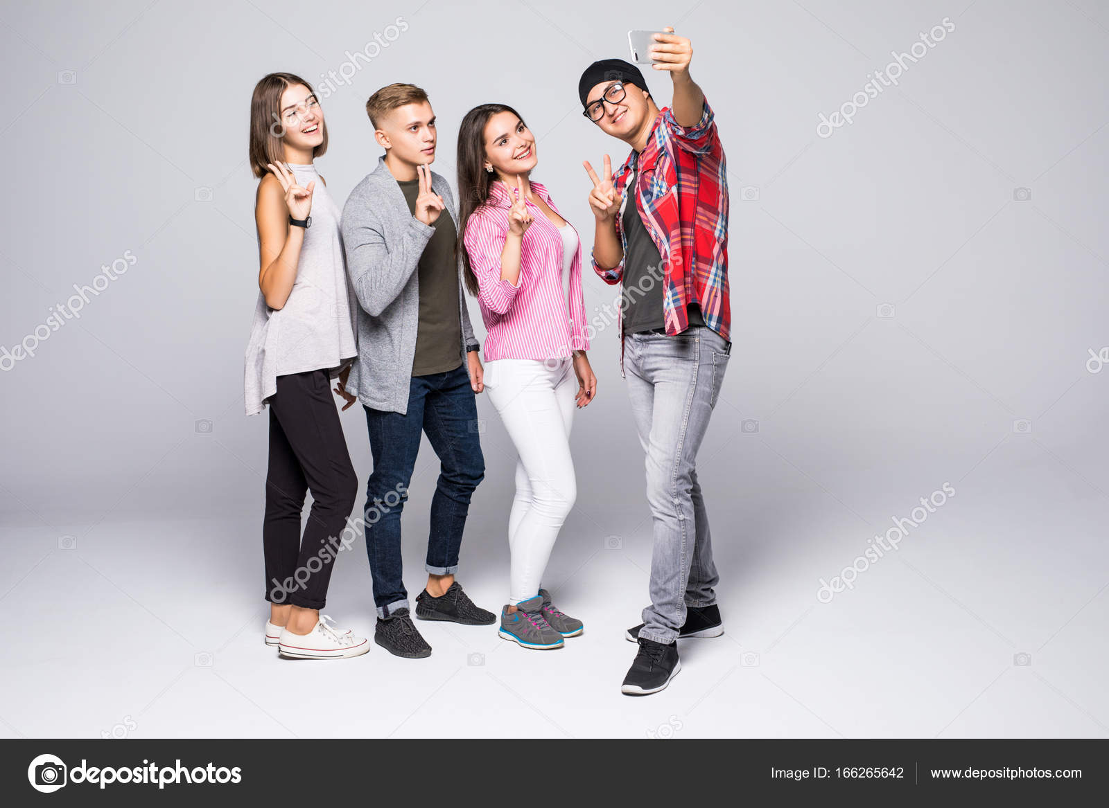 Four friends stylish young people on white background. Stock Photo ...