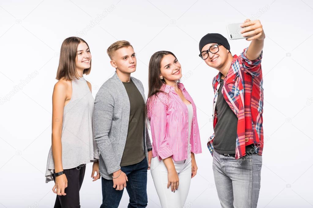 Group of happy young teenager students taking selfie photo isolated on white