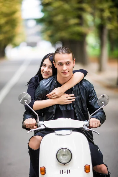 Couple in love riding a motorbike, Handsome guy and young sexy woman travel . Young riders enjoying themselves on trip. Adventure and vacations concept.