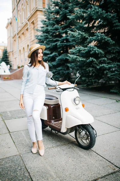 Молодая красавица-кавказка едет на скутере — стоковое фото