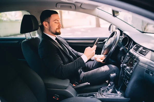Portrait of handsome business man use phone in car while drive — Stock Photo, Image