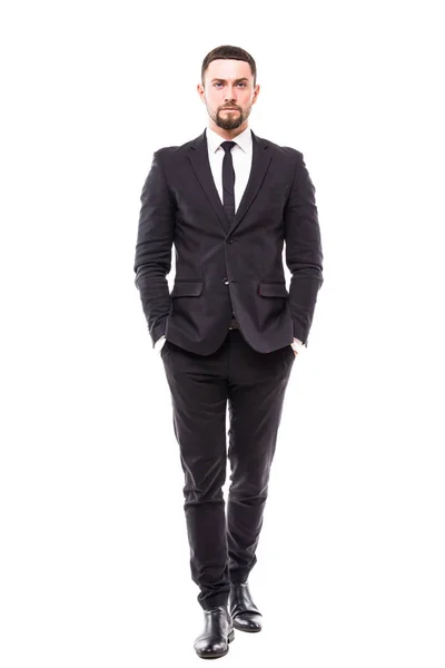 Full length of confident young man in formalwear and eyeglasses holding hands in pockets and looking at camera while standing against grey background — Stock Photo, Image