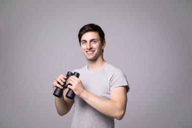 Beyaz arka plan üzerinde izole dürbün ile yakışıklı delikanlı