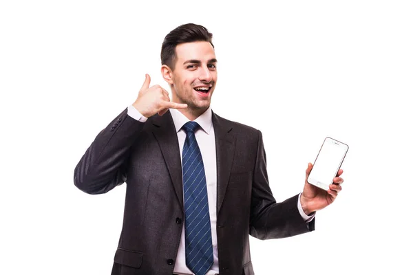 Mladý atraktivní muž v modrém obleku s telefonem volání gesto rukou mi ukazuje na bílém — Stock fotografie