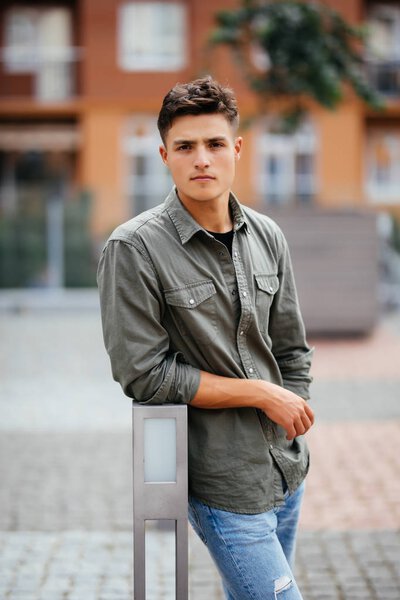 Handsome smiling young man portrait. Cheerful man looking at camera