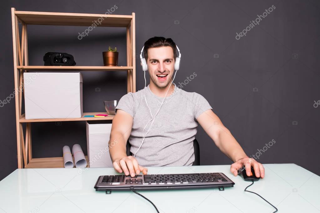 technology, gaming, entertainment, let's play and people concept - screaming young man in headset with pc computer playing game at home and streaming playthrough or walkthrough video