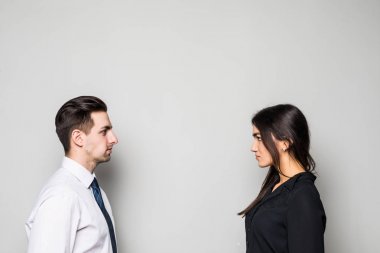 Yüzleşme işindeki kavramı. Gençlerin birbirlerine gri üzerine yüz yüze duran iki ciddi emin fotoğraf kapatmak