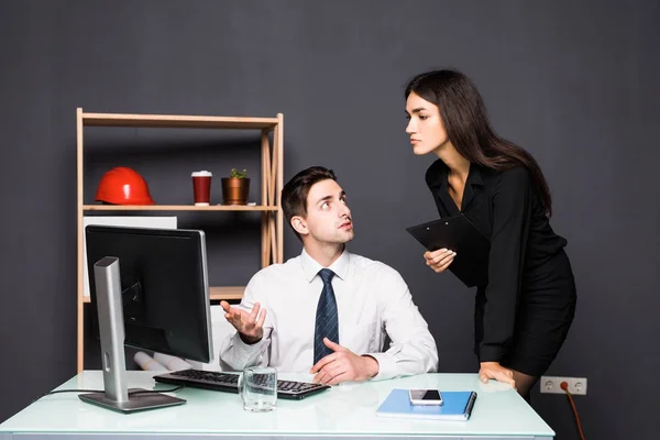 Attractive photo editor pointing at the screen while working with a colleague at office — Stock Photo, Image