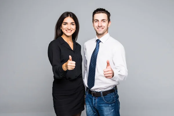 Gente de negocios que tiene sus pulgares en el fondo gris — Foto de Stock