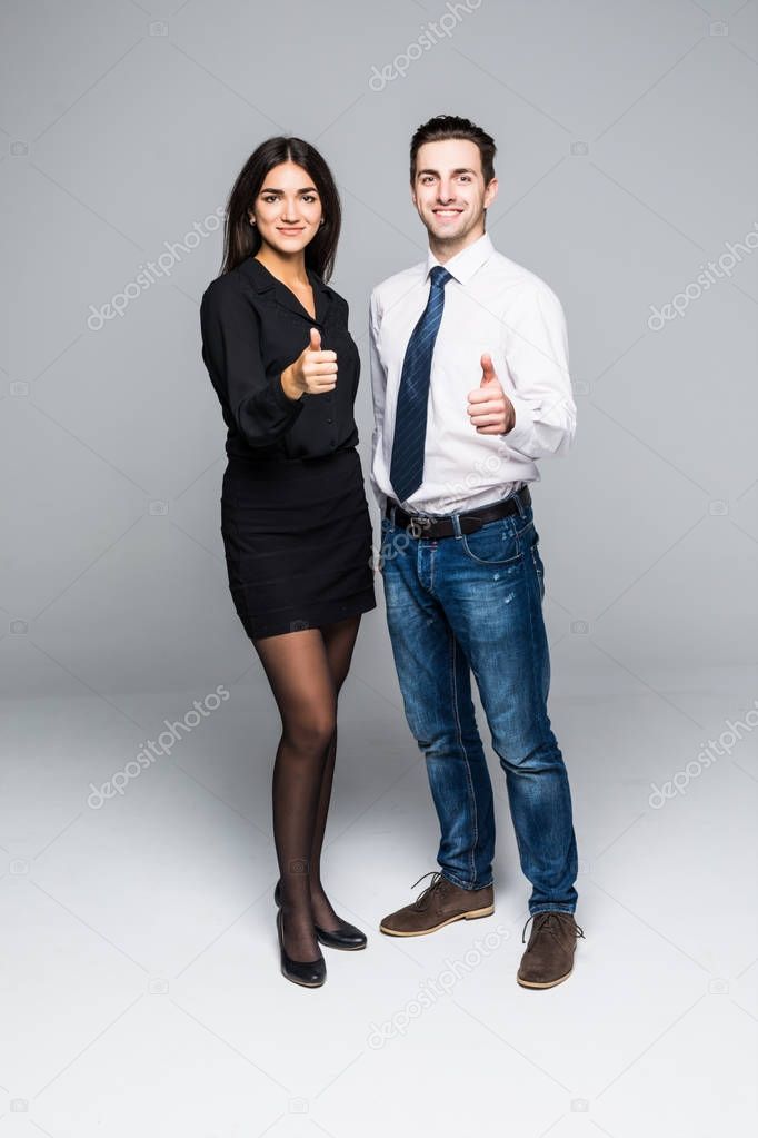 Business people who have their thumbs up on gray background