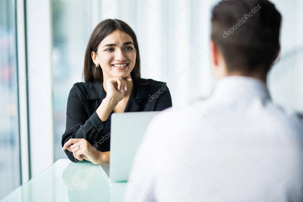 Coworkers talking in the office. Business partners in the office, focus on woman.