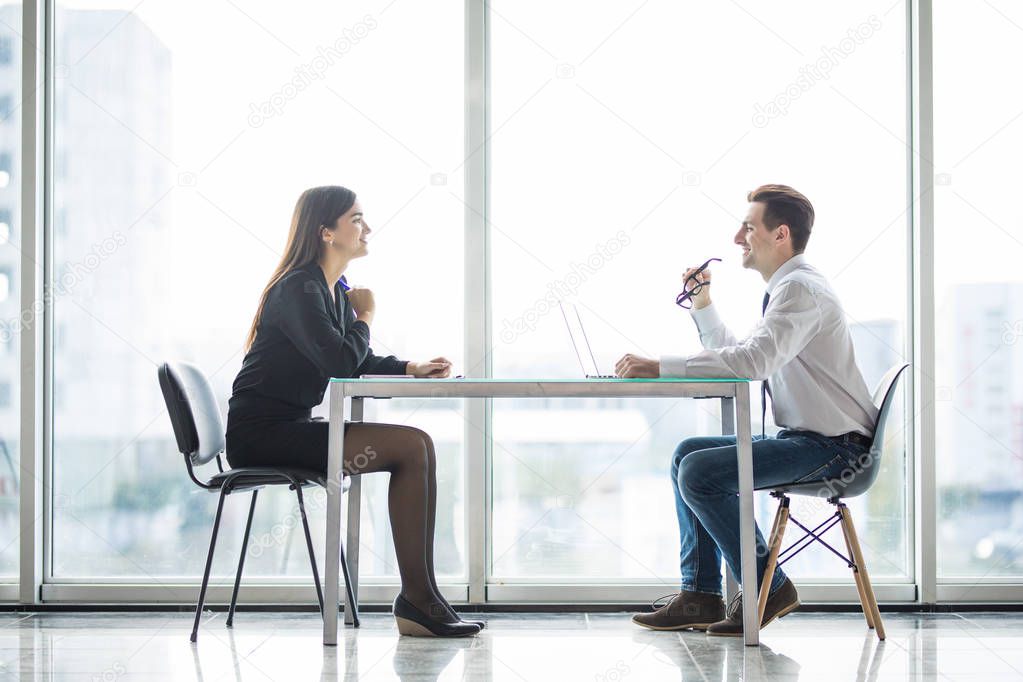 Businessman And Businesswoman Meeting In Modern Office face to face discuss plans