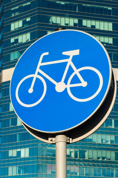Bicycle sign on skycrappers background. Bycicle road