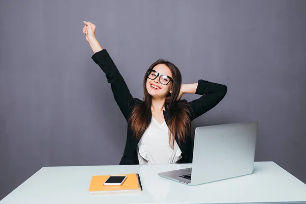 Porträt einer glücklichen jungen erfolgreichen Geschäftsfrau, die etwas mit erhobenen Armen feiert. glückliche Frau sitzt im Büro und schaut auf Laptop. Positive Emotionen. — Stockfoto