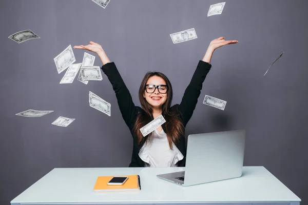 Mujer de negocios en su oficina lugar de trabajo tirar el dinero volando sobre el ordenador portátil — Foto de Stock